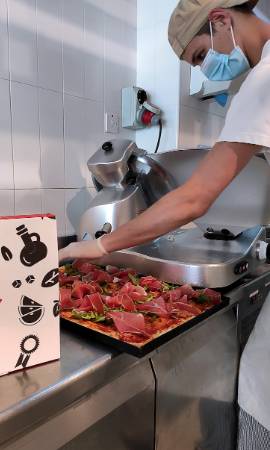 Alice Pizza staff preparing the pizzas to be delivered at Mater Dei Hospital and five church homes for children